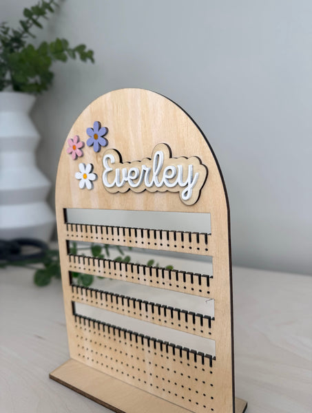 A jewelry organizer with name and daises 