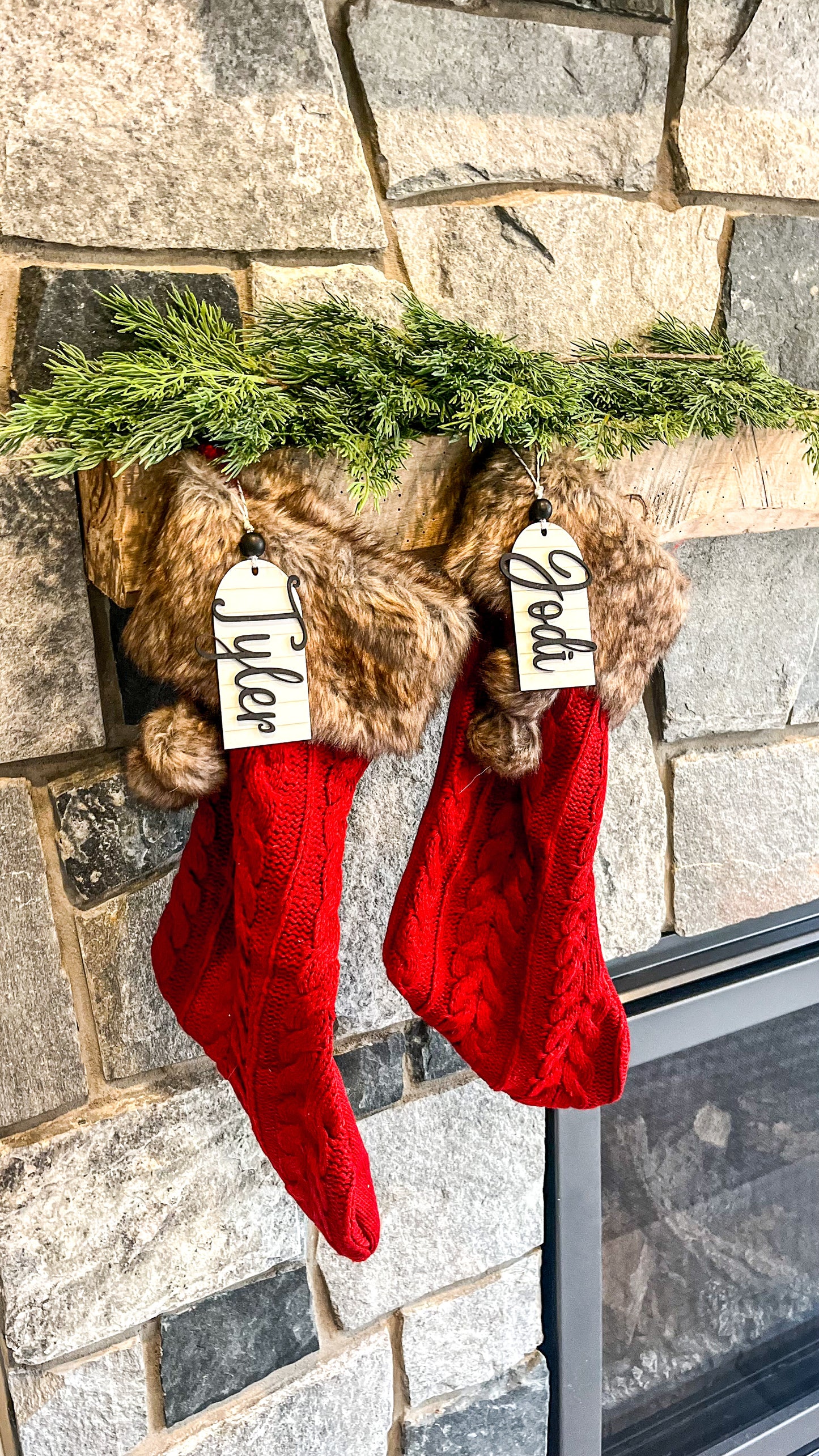 Personalized Stocking tags with names.  Stocking tags are white shiplap with Black wooden lettering